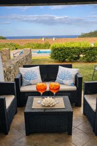 two wine glasses sitting on top of a table at Villa Beafe' Ogliastra con piscina in Tertenìa