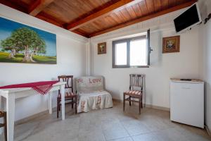 a room with a table and chairs and a window at Villa Tonia in Fasano