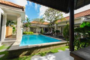 a swimming pool in the backyard of a house at Canggu Bagus Suites in Canggu