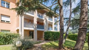 an apartment building with trees in front of it at L'Écrin du Petit Prince SoCozy in Toulouse