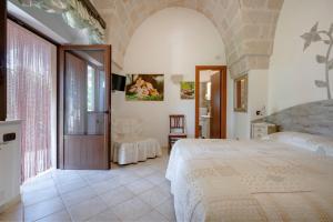 a bedroom with a large bed and a large window at Villa Tonia in Fasano +97 photos