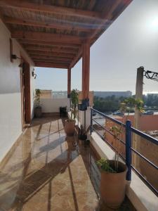 a balcony with potted plants on top of a building at Tamrazen retreat in Tamraght Ouzdar +17 photos