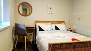 a bedroom with a bed and a desk and a chair at 111 3rd Avenue Tauranga in Tauranga