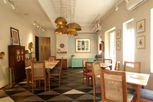 a restaurant with tables and chairs in a room at Amrit Bhawan in Haridwār