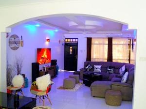 a living room with a couch and a fireplace at Rosa Mystica Diani Bnb in Ukunda Airport