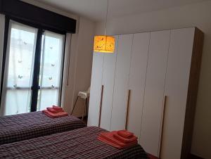 a bedroom with two beds with red towels on them at Bright apartment between Como and Milan in Lurago Marinone