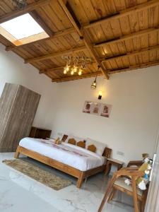 a bedroom with a bed and a wooden ceiling at frozen valley in Mukteshwar