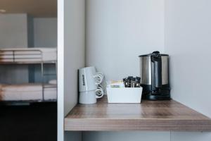 a kitchen counter with a coffee maker on a table at Rotterdam Teleport Hostel in Rotterdam +12 photos