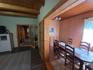 a dining room with a table and wooden walls at Cabana Anita in Sovata