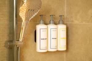 three bottles of soap and a hair brush on a wall at Park Inn by Radisson Antwerp City Centre in Antwerp +33 photos