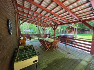 a covered patio with a table and pool tables at Cabana Anita in Sovata +5 photos