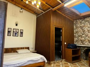 a bedroom with a bed and a fireplace at frozen valley in Mukteshwar +6 photos