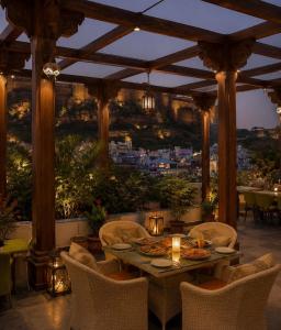 a patio with a table and chairs with a view at JHANKAR Haveli in Jodhpur