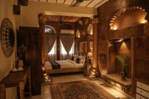 a bedroom with a bed and a fireplace at JHANKAR Haveli in Jodhpur +29 photos