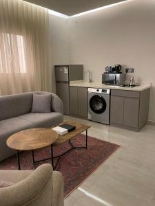 a living room with a couch and a table at شقق سكنية بالربوة2 in Medina
