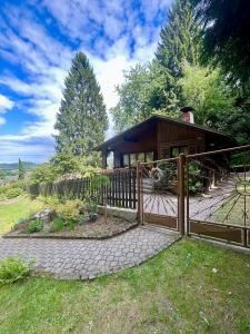a house with a wooden fence in front of it at U čerchovského pramene in Pec