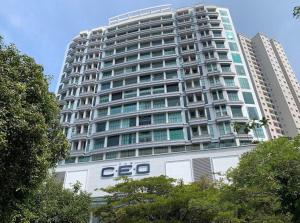 a large building with an eo sign in front of it at The Ceo Suites in Bayan Lepas