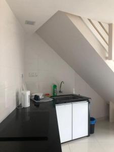 a kitchen with a sink and a counter top at The Ceo Suites in Bayan Lepas