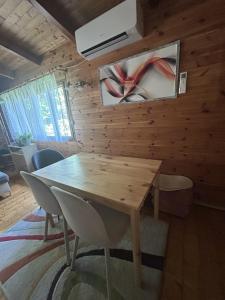 a dining room with a wooden wall with a table at U čerchovského pramene in Pec +19 photos