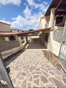a balcony of a house with a patio at Leoni's House in Calasetta