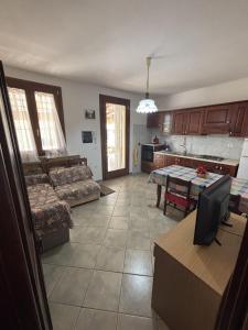 a living room with a couch and a table at Leoni's House in Calasetta