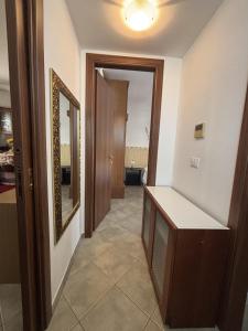 a room with a hallway with a mirror and a door at Leoni's House in Calasetta +5 photos