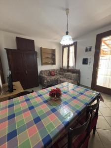 a living room with a table with a colorful table cloth at Leoni's House in Calasetta