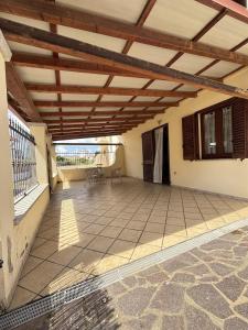 a patio with a wooden pergola on a house at Leoni's House in Calasetta