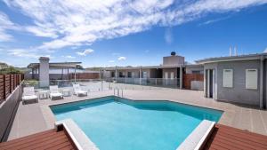 a swimming pool on the roof of a house at Solaris in Fingal Bay