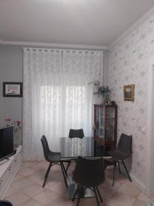a dining room with a table and chairs and a television at Casa Patrizia in Velletri