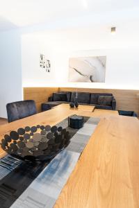 a large wooden table in a living room at Chalet Maier in Landschach +31 photos