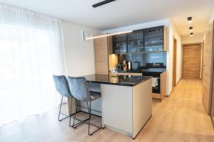 a kitchen with a counter and two chairs at Chalet Maier in Landschach