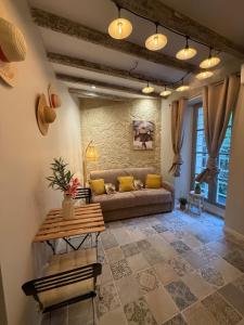 a living room with a couch and a table at Gambetta in Arles +1 photo