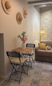 a living room with a table and chairs and a couch at Gambetta in Arles
