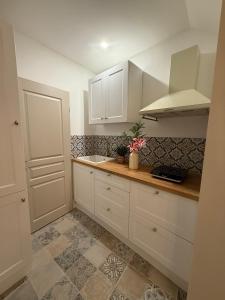 a kitchen with white cabinets and a counter top at Gambetta in Arles