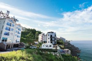 a group of buildings on a hill next to the ocean at Samcheok eastocean in Samcheok
