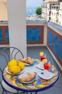 a table with food and drinks on a balcony at Meublè Casa Mannini Rooms in Maiori