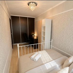 a bedroom with a bed with two towels on it at Central Warsaw Apartment with Pool & Sauna in Warsaw +7 photos