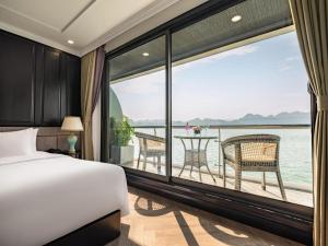 a bedroom with a bed and a view of the ocean at Cruise Lan Ha Bay 2 Day 1 Night pick-up from Cat Ba Central in Cat Ba