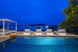 a swimming pool with chairs and a gazebo at Oceans Eleven Villa Samui - Oceanfront, Private Pool, Perfect for families and friends in Bangrak Beach