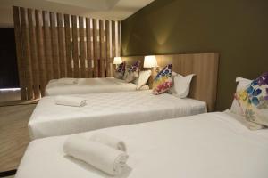 Ένα ή περισσότερα κρεβάτια σε δωμάτιο στο Mornington Hotel Waterfront Lumut