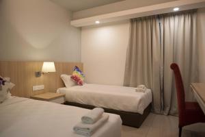 Ένα ή περισσότερα κρεβάτια σε δωμάτιο στο Mornington Hotel Waterfront Lumut