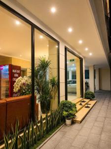 a lobby with potted plants in a building at Khách sạn Solea VIỆT TRÌ in Việt Trì