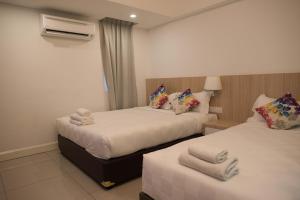 Ένα ή περισσότερα κρεβάτια σε δωμάτιο στο Mornington Hotel Waterfront Lumut