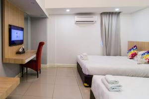 Ένα ή περισσότερα κρεβάτια σε δωμάτιο στο Mornington Hotel Waterfront Lumut