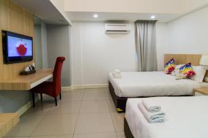 Ένα ή περισσότερα κρεβάτια σε δωμάτιο στο Mornington Hotel Waterfront Lumut