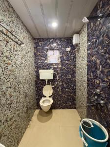 a bathroom with a toilet in a room at New Krishna Hotel Matheran in Matheran