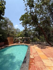 a swimming pool in a yard with trees at New Krishna Hotel Matheran in Matheran