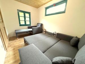 a living room with a couch and a chair at Chalupa Renatka in Hartvíkovice