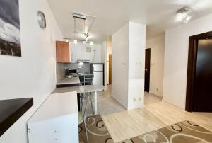a kitchen with white walls and a counter top at Central Warsaw Apartment with Pool & Sauna in Warsaw